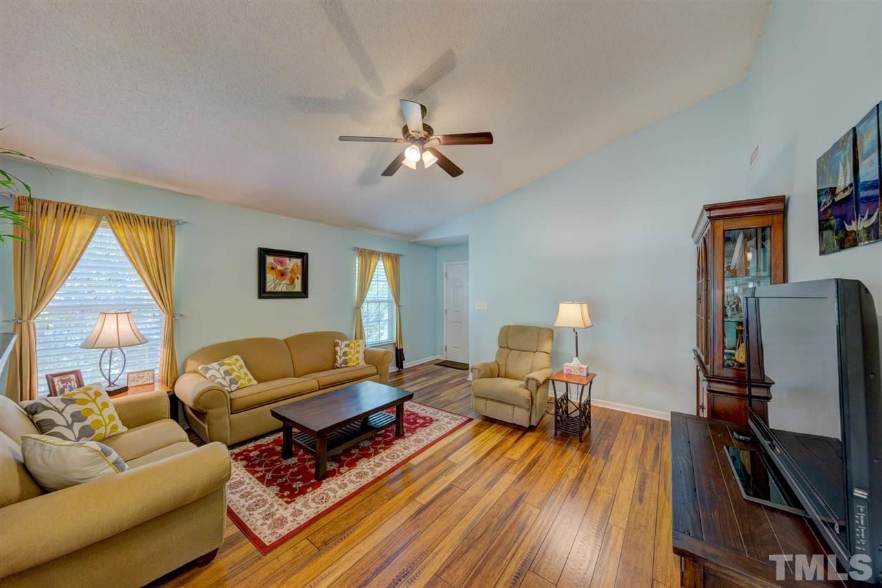 4845 Silverdene Street Raleigh, NC 27616 - Photo 7 of 24 a living room with furniture fireplace and a flat screen tv