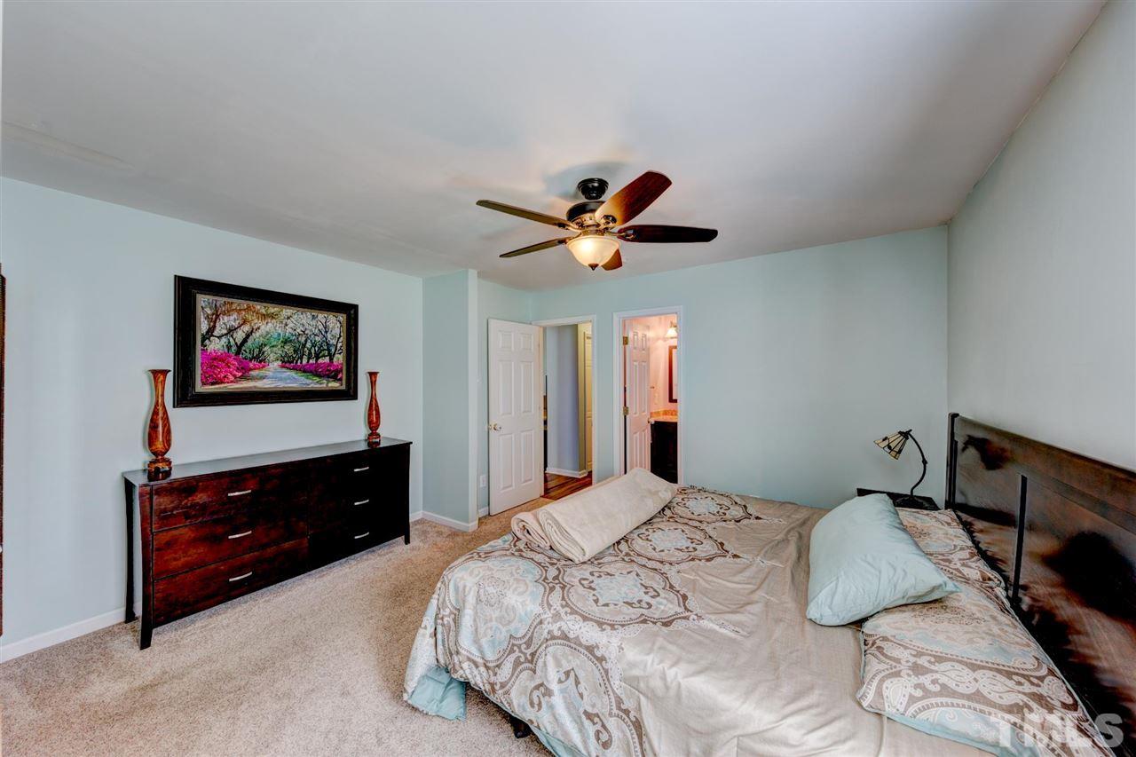 4845 Silverdene Street Raleigh, NC 27616 - Photo 10 of 24 a bedroom with a bed and a flat screen tv