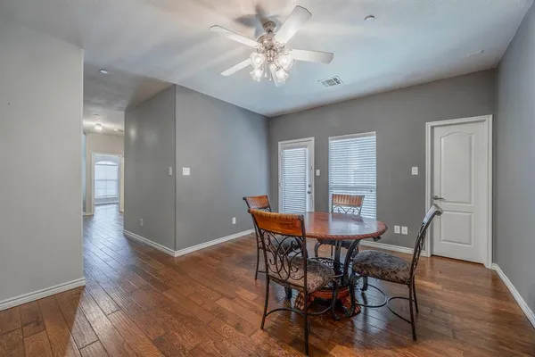 a view of a dining room with furniture and wooden floor