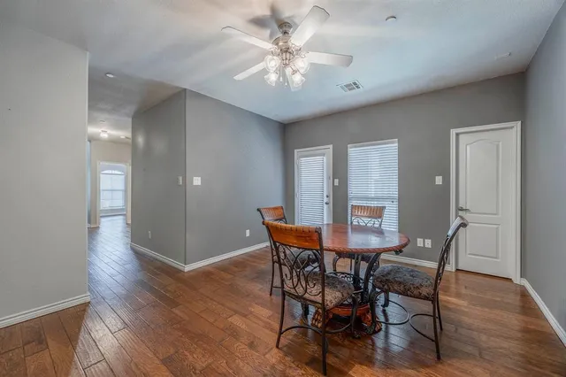 a view of a dining room with furniture and wooden floor