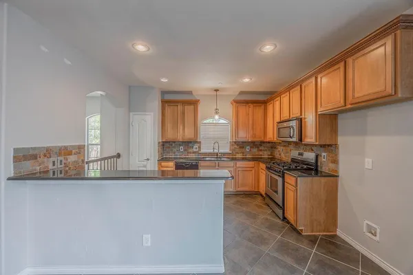 a kitchen with lots of counter top space and appliances