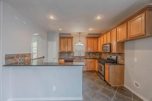 a kitchen with lots of counter top space and appliances