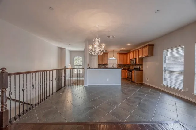 a view of a kitchen with kitchen and stainless steel appliances
