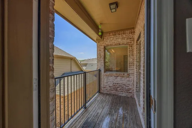 a view of a balcony with wooden floor
