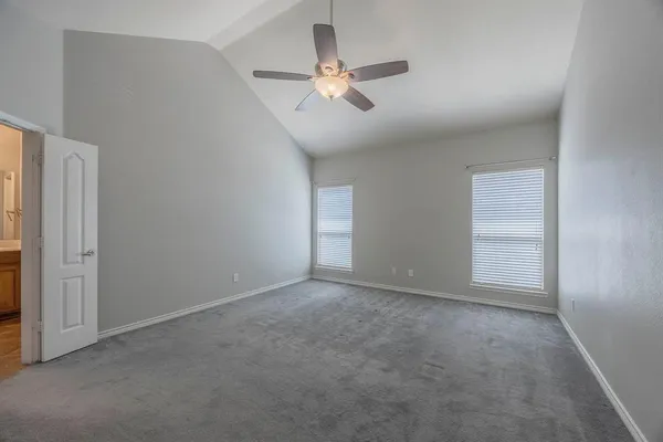 a view of an empty room with a ceiling fan