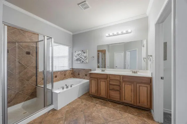 a bathroom with a tub sink and mirror