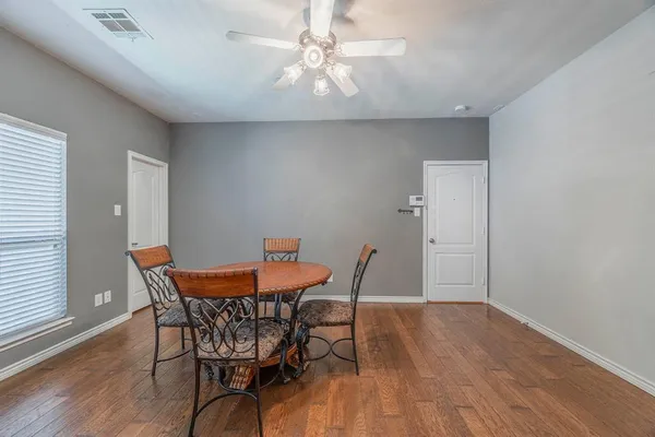 a view of a dining room with furniture and wooden floor