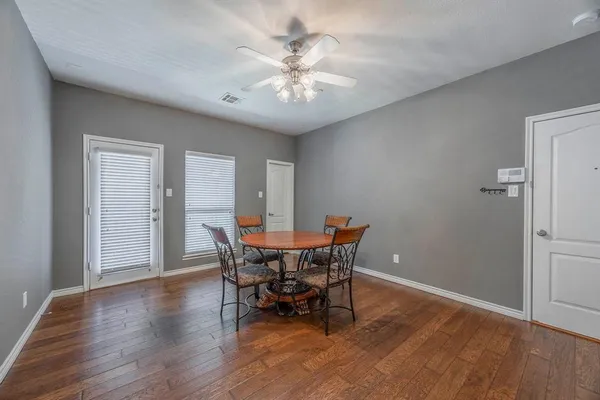 a view of a dining room with furniture and wooden floor