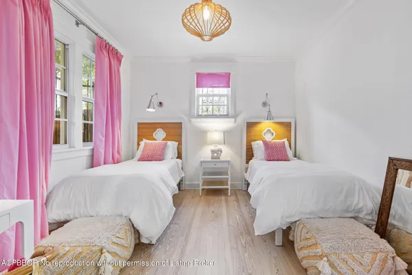 a spacious bedroom with a bed and a chandelier