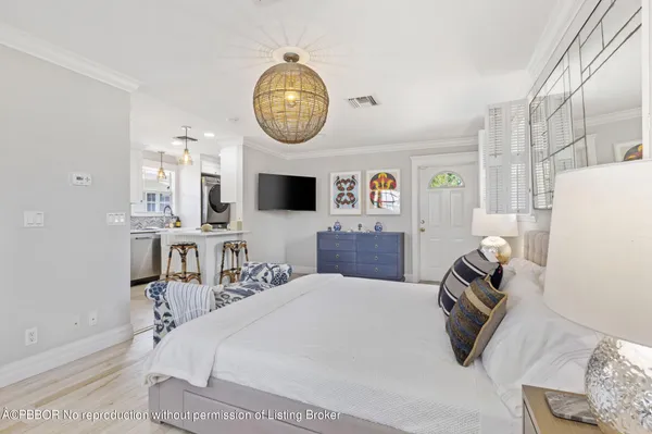 a kitchen with stainless steel appliances a refrigerator a stove a sink and a island