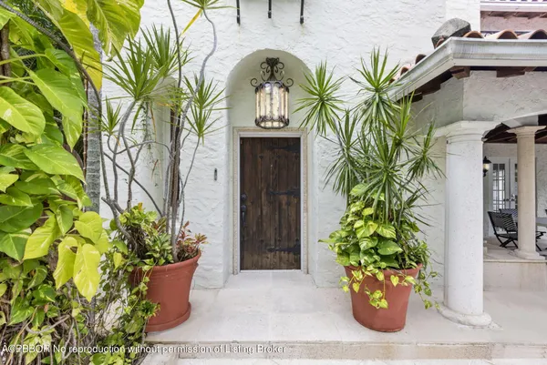 a front view of a house with plants