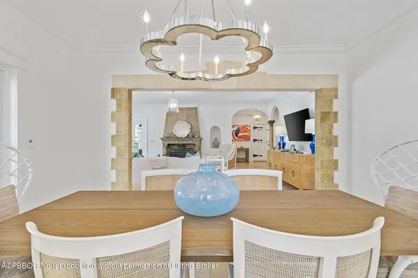 a living room with table and chairs