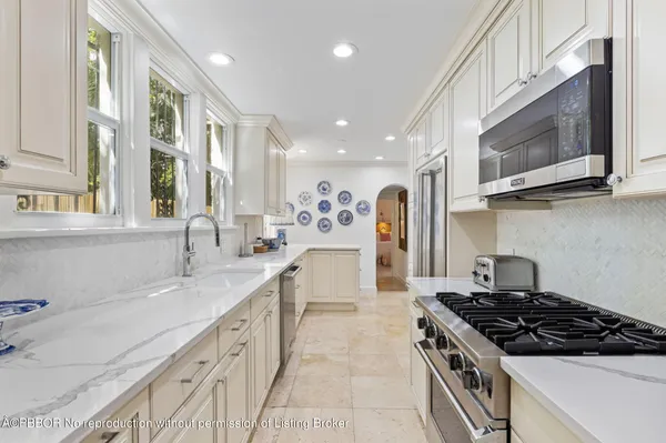a kitchen with stainless steel appliances granite countertop a sink stove and microwave