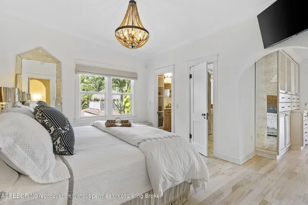 a bedroom with a bed and a chandelier
