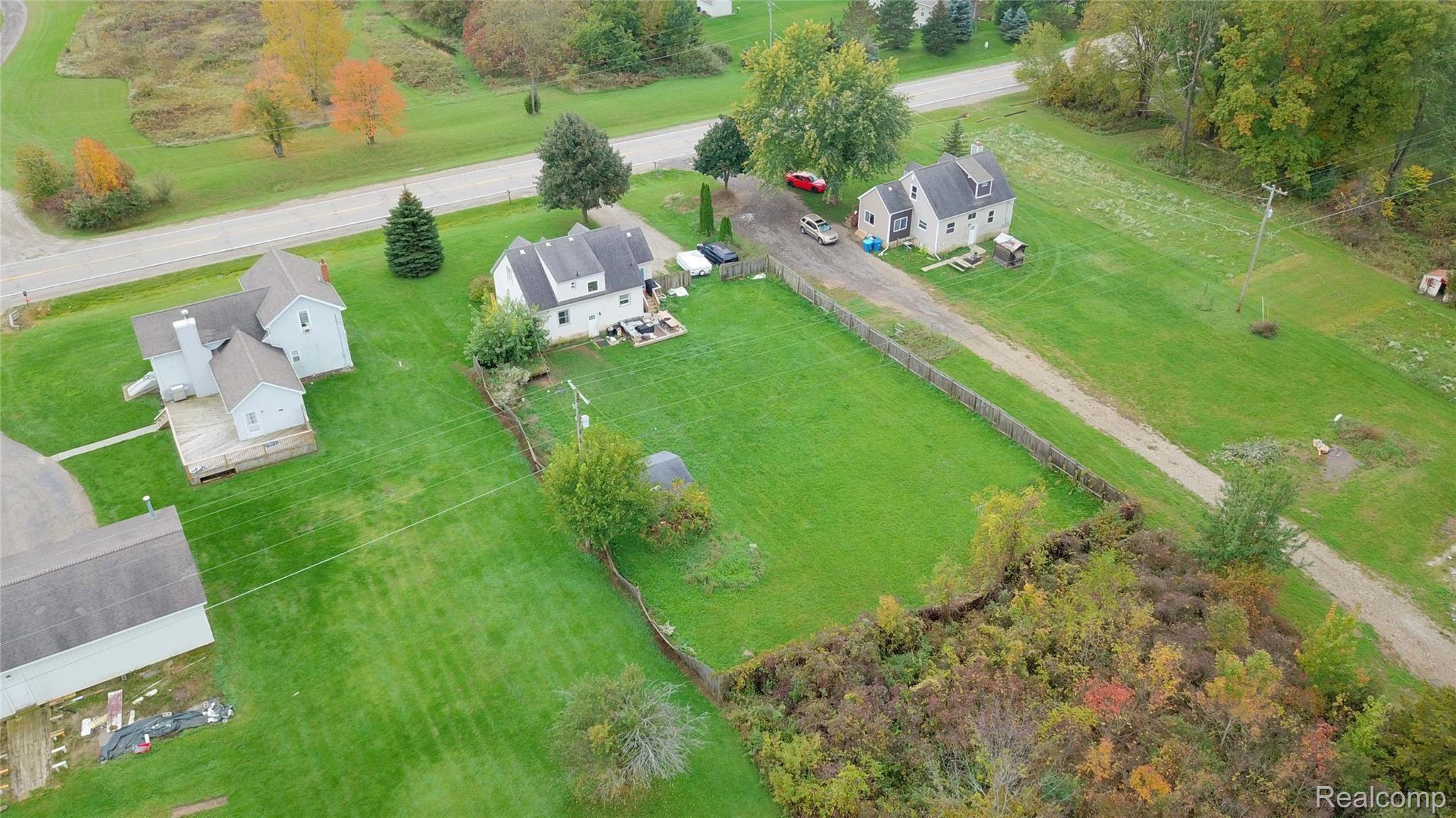 4374 Lahring Road Linden, MI 48451 - Photo 14 of 17 Fenced Backyard and Home