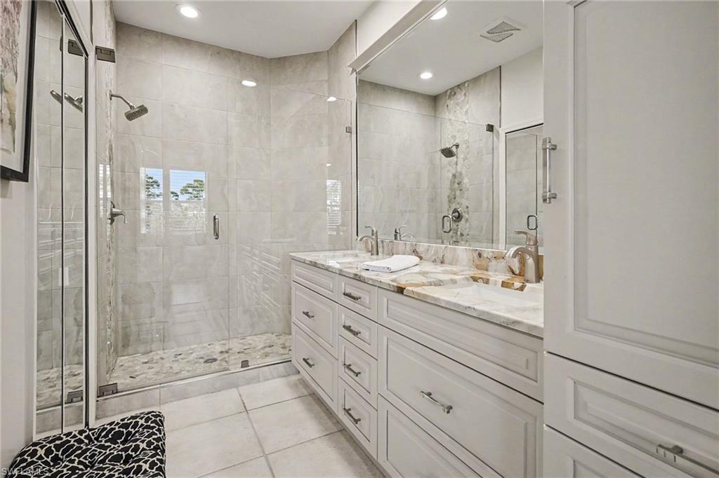 9341 Spring Run Boulevard, Unit 3108 Estero, FL 34135 - Photo 20 of 30 Bathroom featuring double vanity, a stall shower, light tile patterned flooring, and recessed lighting