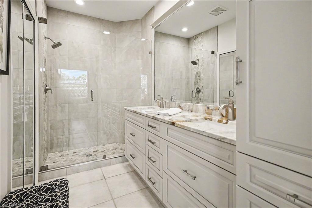 9341 Spring Run Boulevard, Unit 3108 Estero, FL 34135 - Photo 21 of 30 Full bathroom with double vanity, a shower stall, light tile patterned floors, and recessed lighting