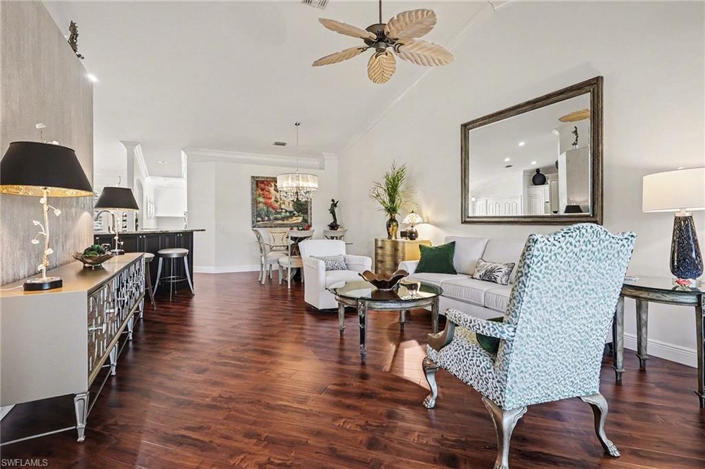 9341 Spring Run Boulevard, Unit 3108 Estero, FL 34135 - Photo 3 of 30 Living room featuring dark wood finished floors, a ceiling fan, vaulted ceiling, recessed lighting, and crown molding
