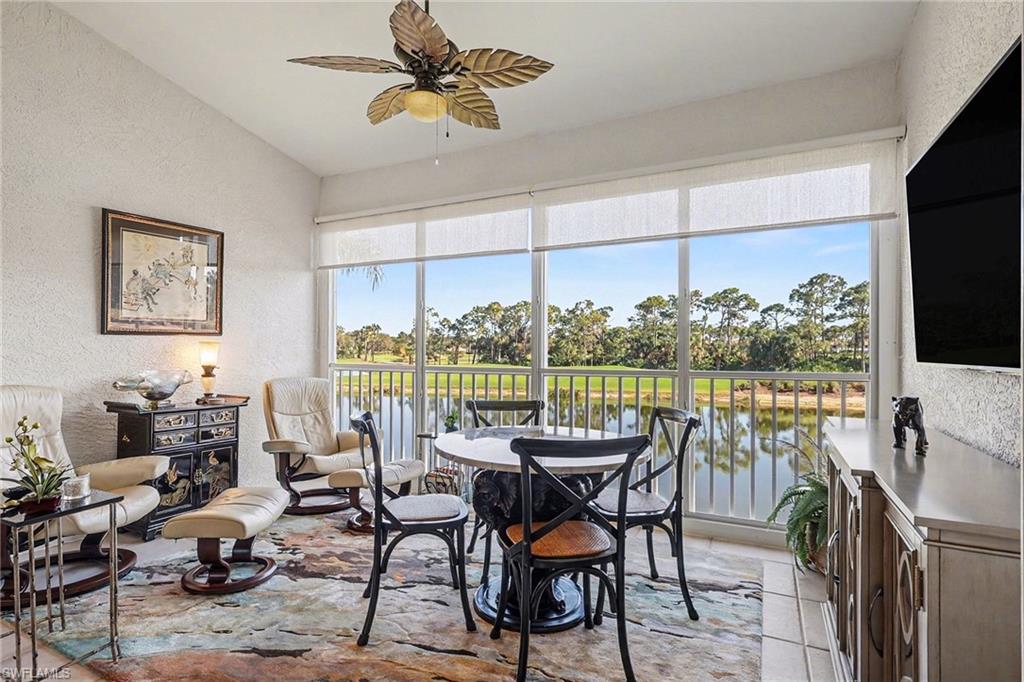 9341 Spring Run Boulevard, Unit 3108 Estero, FL 34135 - Photo 5 of 30 Dining space featuring a textured wall, ceiling fan, plenty of natural light, water and golf course view