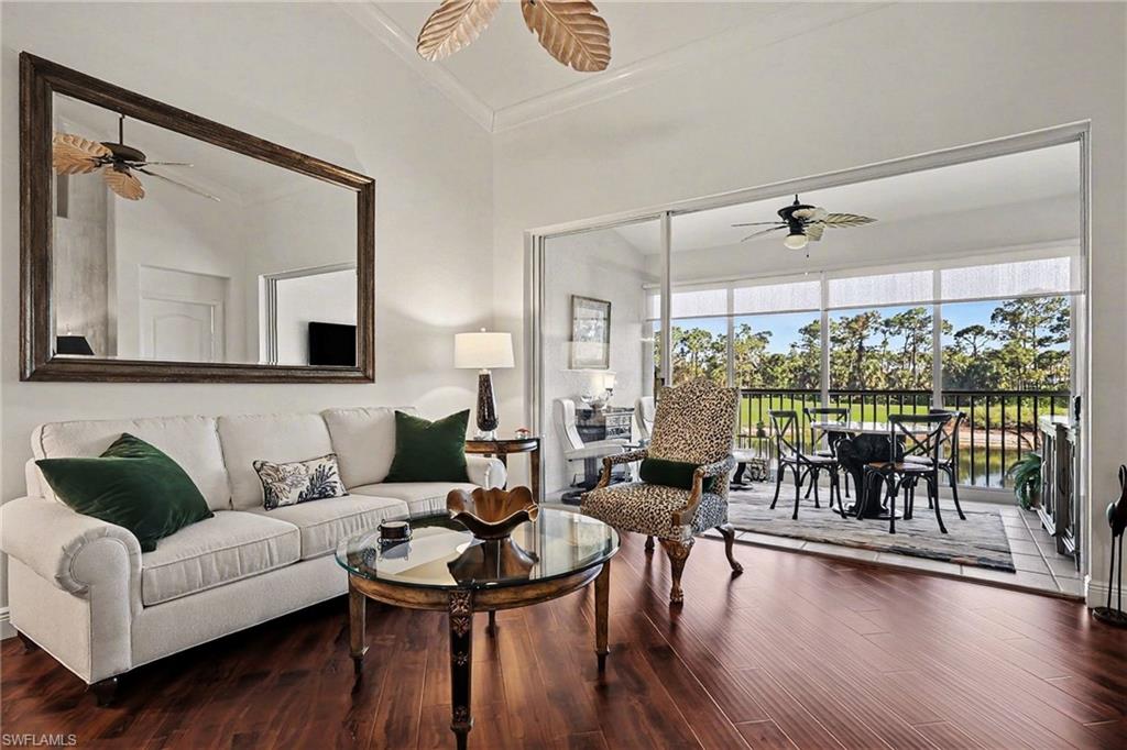 9341 Spring Run Boulevard, Unit 3108 Estero, FL 34135 - Photo 6 of 30 Living area featuring a ceiling fan, wood finished floors, and ornamental molding