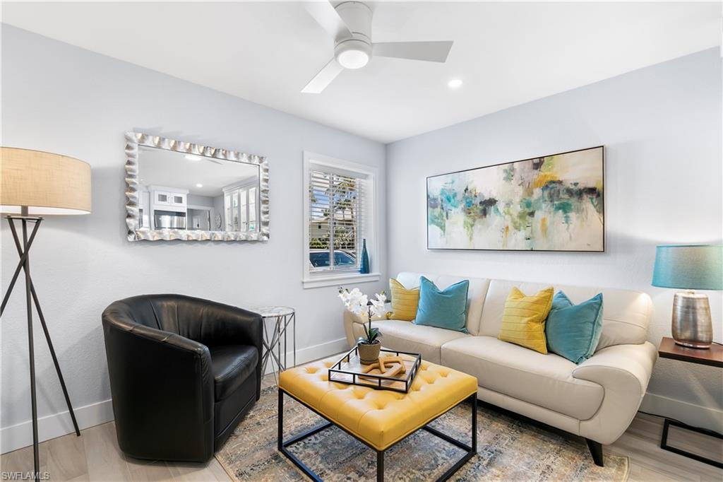 175 5th Avenue South, Unit 3 Naples, FL 34102 - Photo 12 of 31 a living room with furniture and a painting on the wall