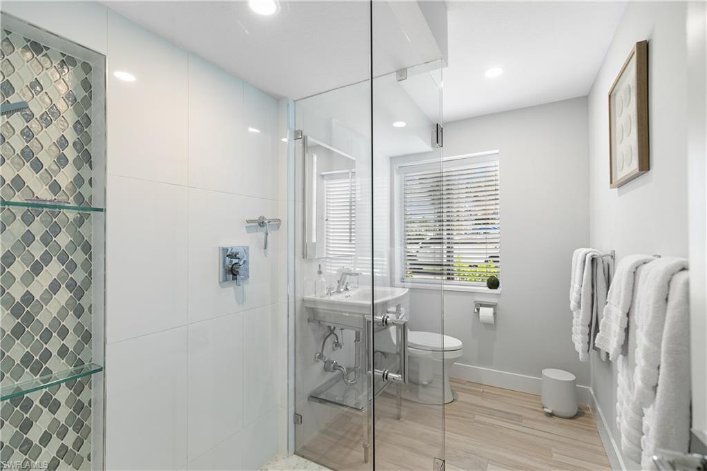 175 5th Avenue South, Unit 3 Naples, FL 34102 - Photo 16 of 31 a bathroom with a shower and a toilet