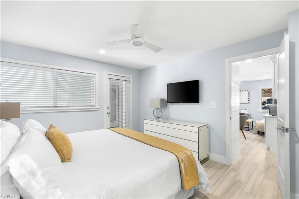 175 5th Avenue South, Unit 3 Naples, FL 34102 - Photo 17 of 31 a bedroom with a bed and a flat screen tv