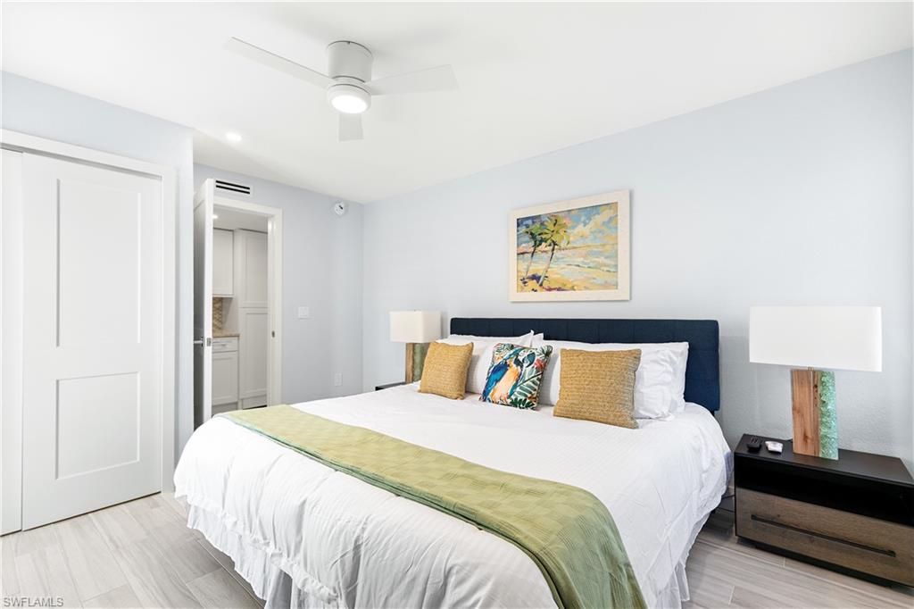175 5th Avenue South, Unit 3 Naples, FL 34102 - Photo 21 of 31 a bedroom with a large bed and a lamp
