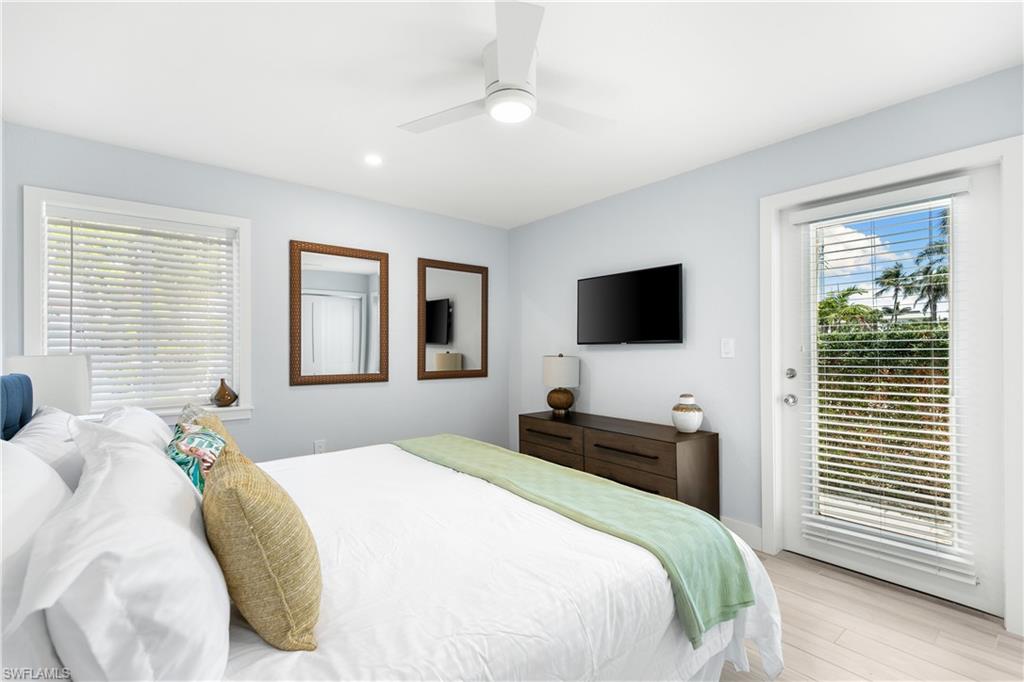 175 5th Avenue South, Unit 3 Naples, FL 34102 - Photo 22 of 31 a bedroom with a bed tv and a window