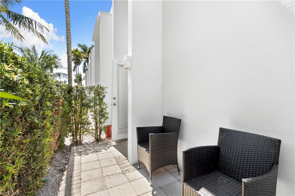 175 5th Avenue South, Unit 3 Naples, FL 34102 - Photo 23 of 31 a backyard of a house with outdoor seating