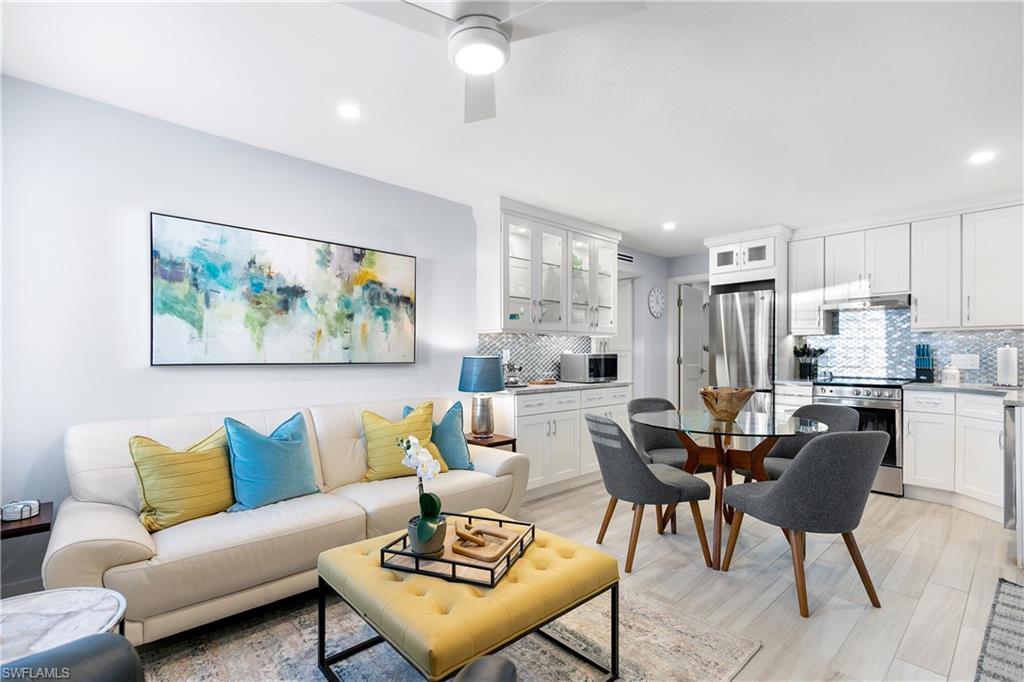 175 5th Avenue South, Unit 3 Naples, FL 34102 - Photo 5 of 31 a living room with furniture and a painting