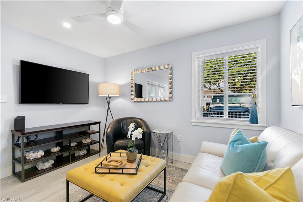 175 5th Avenue South, Unit 3 Naples, FL 34102 - Photo 10 of 31 a living room with furniture and a flat screen tv