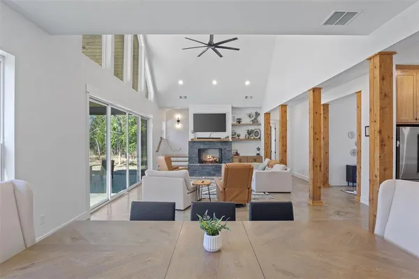 a living room with furniture a fireplace and a chandelier