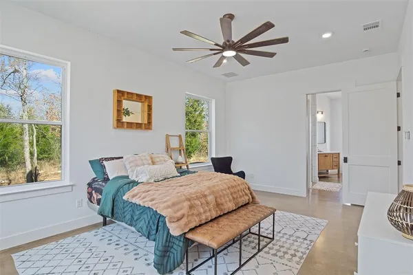 a bedroom with a bed a rug and a window