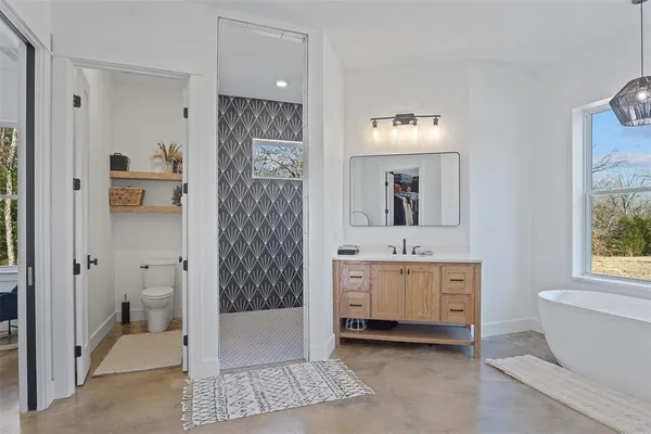 a bathroom with a bathtub sink and mirror