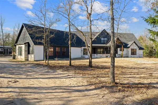 a view of a house next to a road and small yard