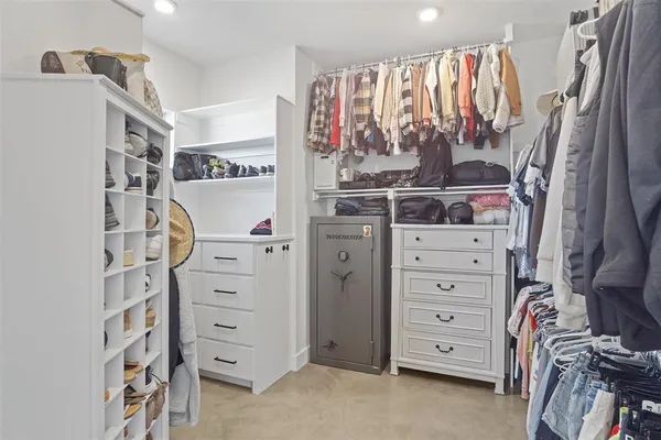 a view of walk in closet with clothes