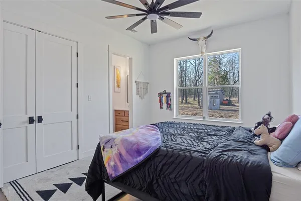a bedroom with a bed and window