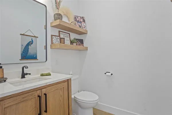a bathroom with a toilet a sink and mirror
