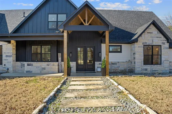 a view of a house with wooden fence