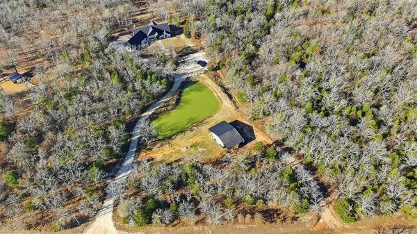 a aerial view of a house with a yard and swimming pool