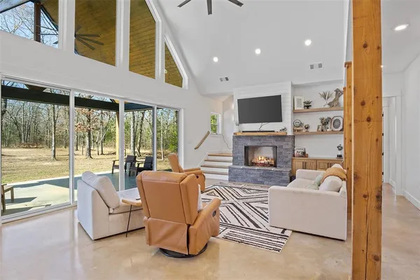 a living room with fireplace furniture and a flat screen tv