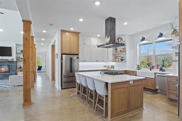a kitchen that has a lot of cabinets a sink and a stove