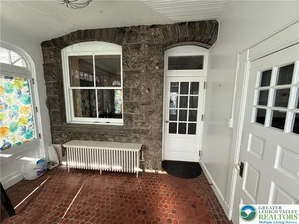 a view of front door of a house with a yard