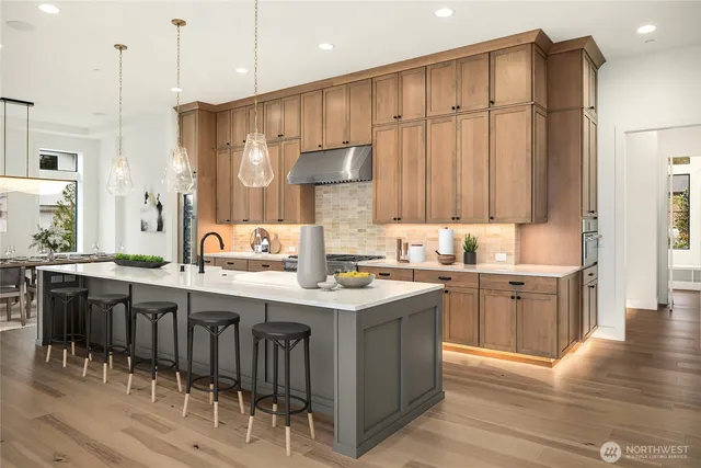 a kitchen with kitchen island granite countertop a sink counter top space and stainless steel appliances