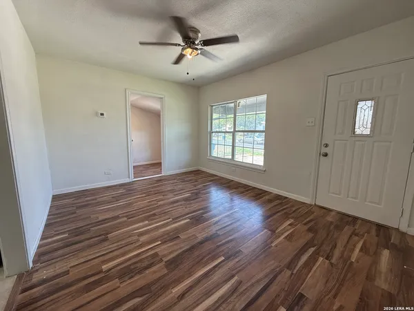 wooden floor in an empty room with a window