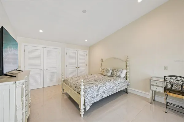 a large bed sitting in a bedroom next to a window