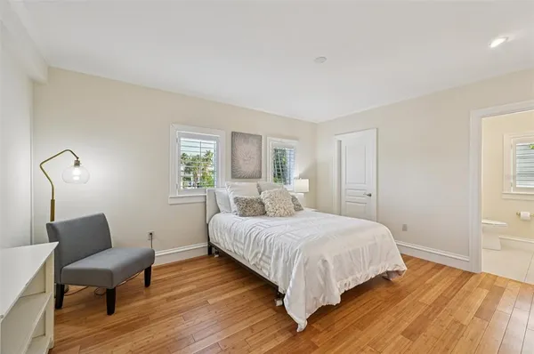 a spacious bedroom with a bed and a window
