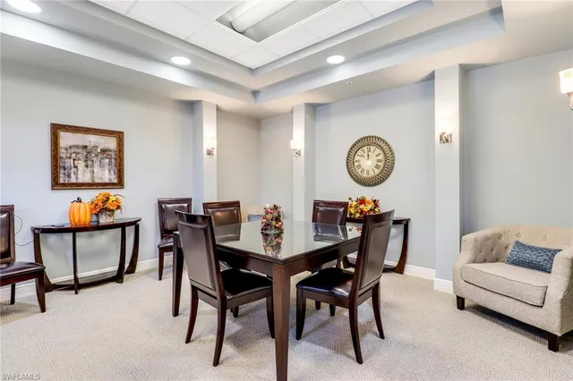 a view of a dining room that has a table and a chair