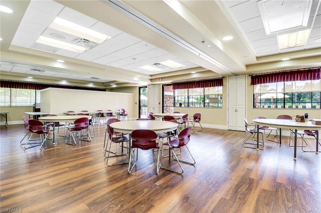 21370 Lancaster Run, Unit 1622 Estero, FL 33928 - Photo 23 of 28 a view of a dining room with furniture and wooden floor